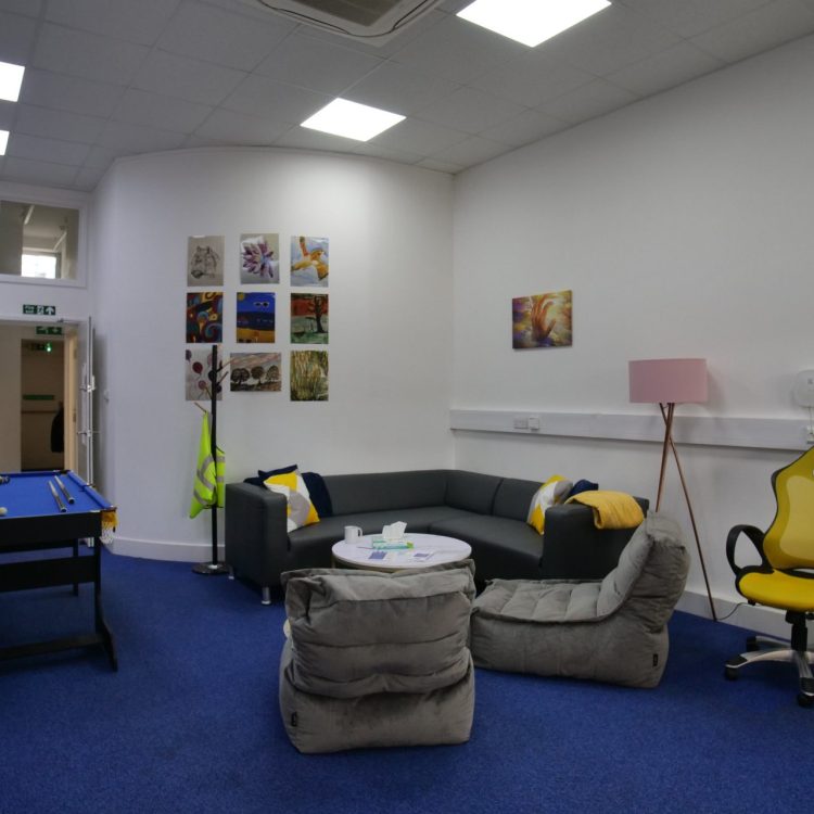 the photo shows an inside room from our Hatfield crisis cafe, including a pool table, sofa, kitchen area and chairs